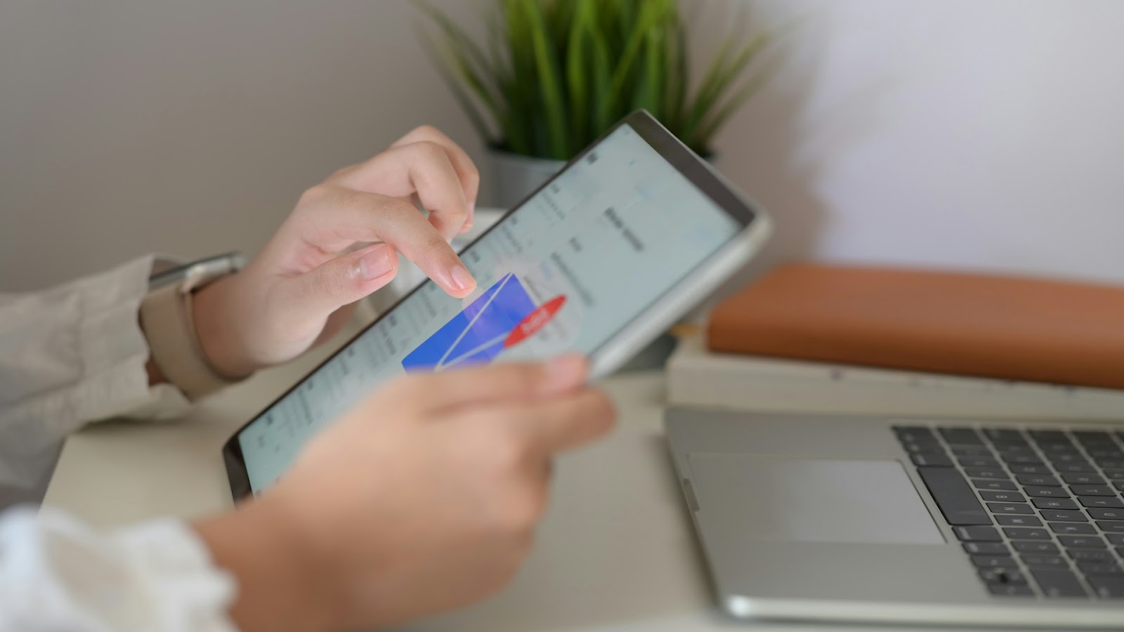 A business owner using a tablet to check her emails